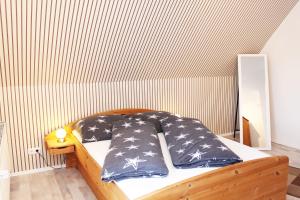 a bed with black and white pillows on it at Ferienwohnung Fina in Bad Bodenteich