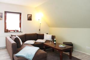 a living room with a couch and a table at Ferienwohnung Fina in Bad Bodenteich