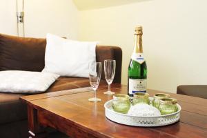 a bottle of wine and two glasses on a table at Ferienwohnung Fina in Bad Bodenteich +17 photos