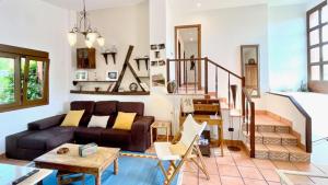 a living room with a couch and a staircase at The Cliffs - Morandaina Beach in O Vicedo +57 photos