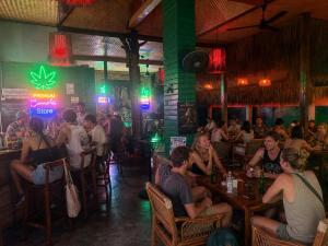 a group of people sitting at tables in a restaurant at Noahs Ark in Lamai