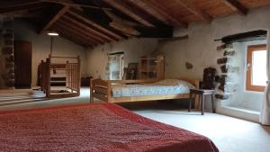 a bedroom with two beds and a window at Logis de Rocles in Rocles