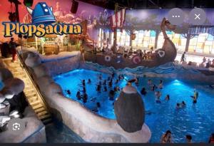a group of people in a pool at a water park at Marine Résidence in De Panne