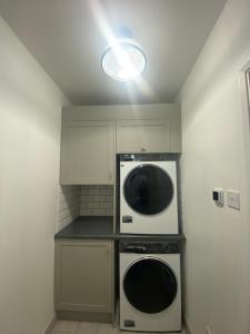 a kitchen with a stove and a microwave at Private room with private bathroom in Hackington