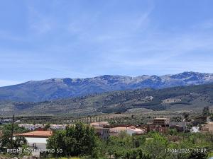 a view of a city with mountains in the background at Gustavo's Old House in Fiñana
