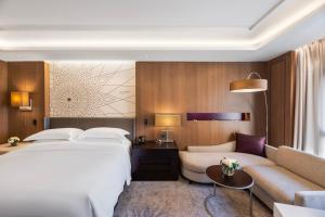a hotel room with a bed and a couch at InterContinental Doha Beach & Spa by IHG in Doha +272 photos