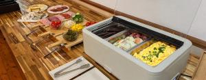 an open refrigerator with food inside of it at Hotel Heluan in Karlovy Vary