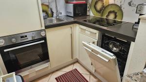 a kitchen with a sink and a stove top oven at Apartment Sara in Koper