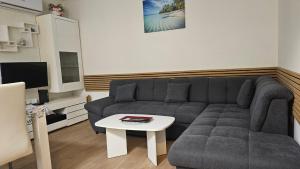 a living room with a couch and a table at Apartment Sara in Koper