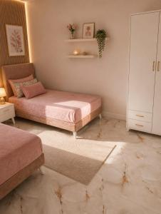 a bedroom with two beds and a cabinet at Appartement chic et luxueux in Rejiche