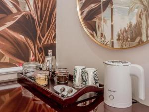 a tray with jars and a coffee pot on a table at Tuli House in Harare