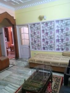 a living room with a couch and a table at Ghar Family-Homestay- 2 Room -Prime Location - Balcony kitchen-Don't book Single Room Book a complete Home in Solan