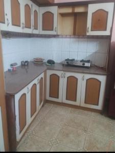 a kitchen with white and brown cabinets in a room at Ghar Family-Homestay- 2 Room -Prime Location - Balcony kitchen-Don't book Single Room Book a complete Home in Solan