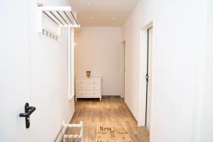 a hallway with a white room with a cross on the wall at Ferienwohnung BEA 1 in Rabenkirchen-Faulück