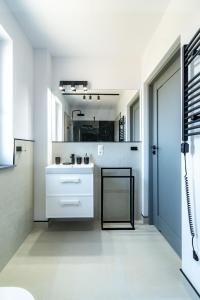 a bathroom with a white sink and a mirror at Morski Resort in Ustka