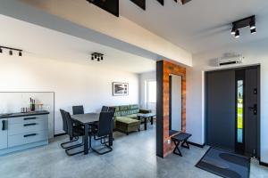 a kitchen and living room with a table and chairs at Morski Resort in Ustka