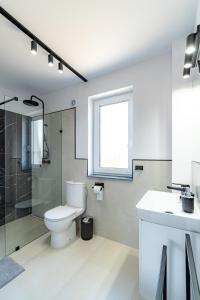 a bathroom with a toilet and a shower and a sink at Morski Resort in Ustka +31 photos