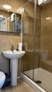 a bathroom with a sink and a shower at The New Inn in Oswestry +18 photos