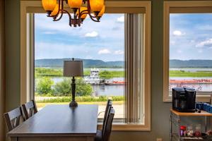 a dining room with a table and a large window at Riverview, 5BR, Hot tub, Fireplace, Arcade Game in Minneiska