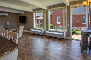 a living room with a table and chairs and windows at Riverview, 5BR, Hot tub, Fireplace, Arcade Game in Minneiska