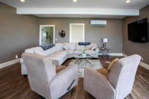 a living room with a couch and two chairs at Riverview, 5BR, Hot tub, Fireplace, Arcade Game in Minneiska +67 photos