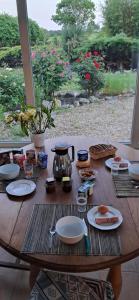 a wooden table with plates of food on it at MAISON d'Hôtes AFRIKA du QUEYROUX , petit gite en campagne proche BERGERAC, 1 seul animal accepté sur demande in Ginestet +16 photos