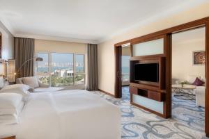 a hotel room with two beds and a television at InterContinental Doha Beach & Spa by IHG in Doha