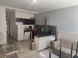 a living room with a couch and a kitchen at superbe t2 centre de cognac in Cognac