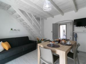 a living room with a table and a couch at Zia Elisa Mare e Comfort - Tertenia in Tertenìa +35 photos