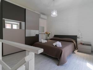 a bedroom with a bed and a large mirror at Zia Elisa Mare e Comfort - Tertenia in Tertenìa