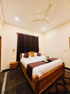 a bedroom with a large bed with a ceiling at The Palace by Boho Travelista in Bhīm Tāl