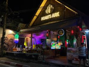 a man standing in front of a restaurant at night at Noahs Ark in Lamai