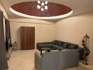 a living room with a couch and a ceiling at Mazari in Marsa Alam City