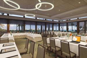 a restaurant with white tables and chairs and windows at Mauna Kea Beach Hotel, Autograph Collection in Hapuna Beach +291 photos