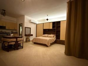 a bedroom with a bed and a table and a kitchen at Mazari in Marsa Alam City +23 photos