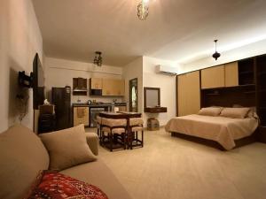 a bedroom with a bed and a kitchen with a table at Mazari in Marsa Alam City