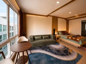 a living room with a couch and a bed at VONLUCK-Wonnapha Beach in Ban Bang Saen (1) +14 photos