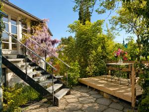 a garden with stairs leading to a house at Boutique Loft Studio in Kreuzlingen