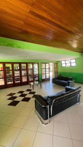 a large room with two beds and a checkered floor at Carranca Grande Hotel in Xique-Xique