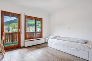 a bedroom with a bed and a large window at Kleeblatt in Bad Wildbad