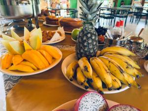 a table topped with plates of bananas and fruit at Carranca Grande Hotel in Xique-Xique +15 photos