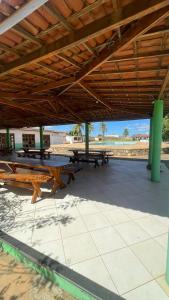 a group of picnic tables sitting under a pavilion at Carranca Grande Hotel in Xique-Xique