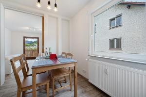 a dining room with a table and chairs and a window at Kleeblatt in Bad Wildbad