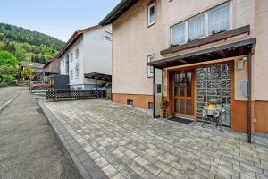 a building with a brick sidewalk in front of a door at Kleeblatt in Bad Wildbad