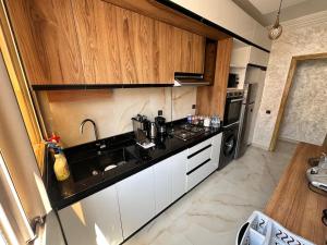 a kitchen with a sink and a counter top at Modern and Cozy in Agadir