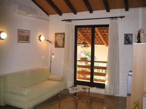 a living room with a couch and a window at Apartment Dady with a large covered terrace in Fažana