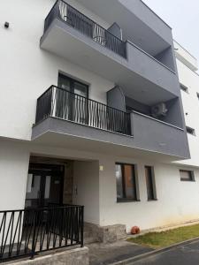 a white building with balconies on the side of it at Apartamente Baile Felix in Baile Felix