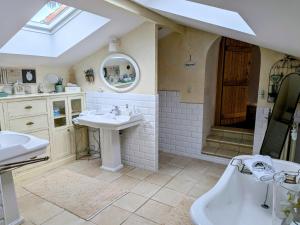 a bathroom with a sink and a tub and a shower at La Grange d'Hélène in Cholet