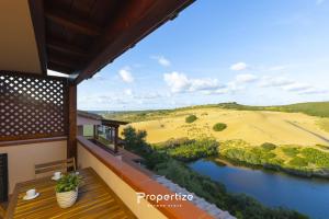 a balcony of a house with a view of a river at Il terrazzo sulla duna 5 by Propertize in Marrùbiu