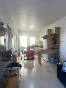a large room with a kitchen and a dining room at Germinada in Imbé